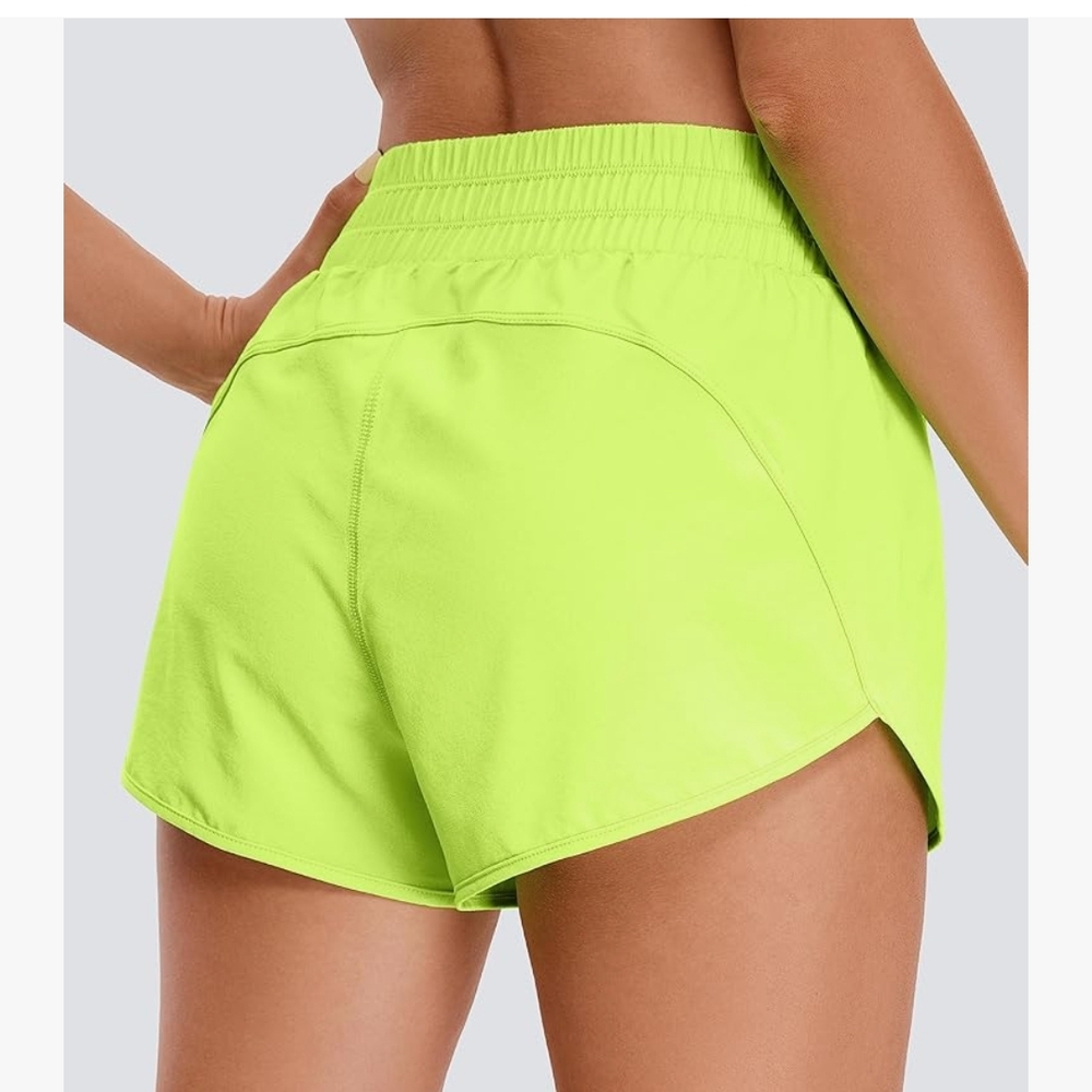 Vibrant Green Athletic Shorts with Curved Hem and Stretchy Fabric